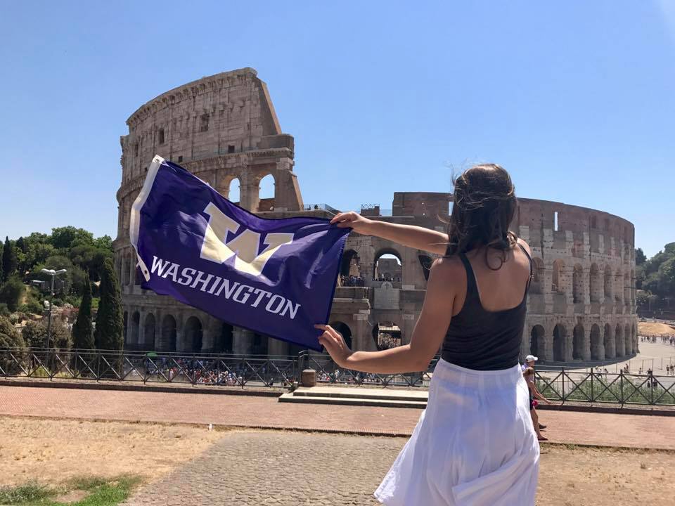 Image of UW student holding a UW flag in Rome