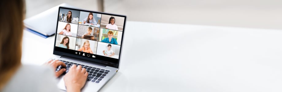 students videoconferencing on teacher's laptop