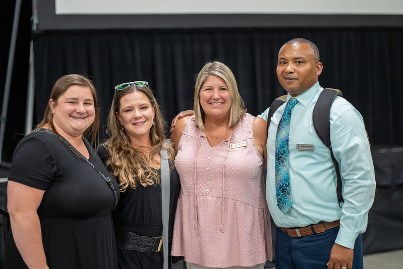 AWSP Staff Three white women and one black man in business casual dress posing together
